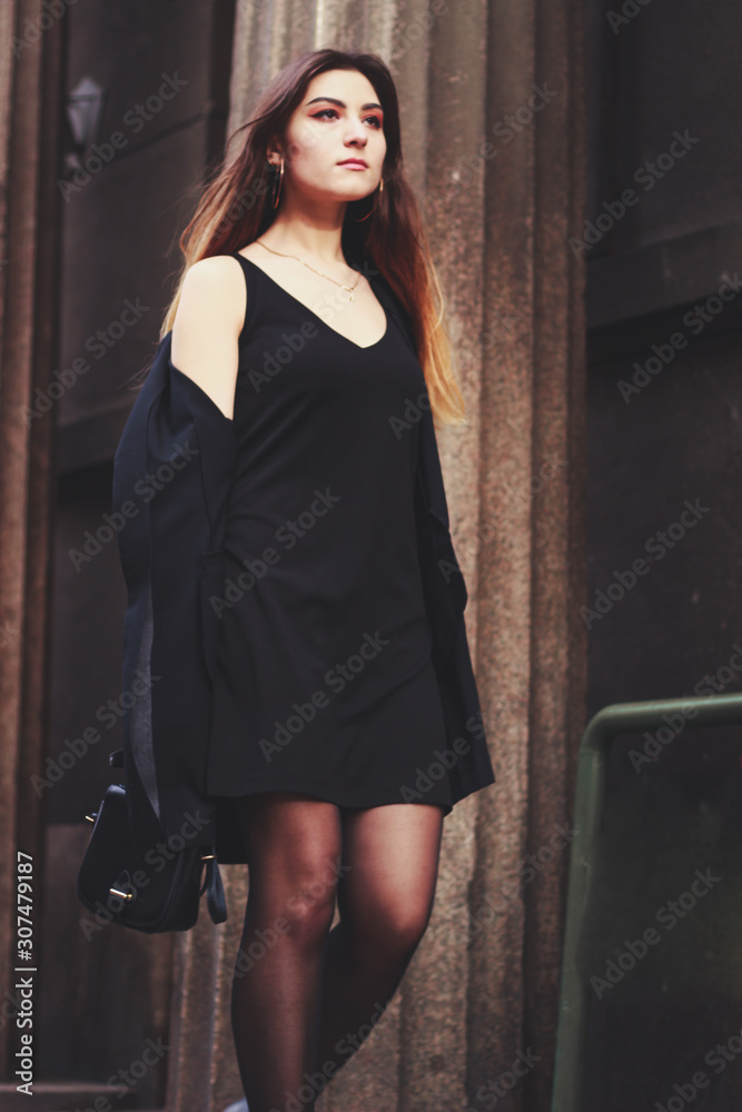 Model in black dress and long jacket. Style. Fashion trends 2020. Hair with ombre. Business lady. Blogger. Work Model in black dress and long jacket. Style. Fashion trends 2020. Hair with ombre. Business lady. Blogger. Work