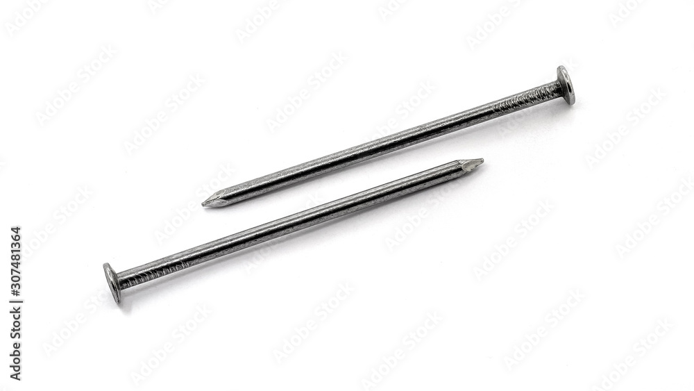Two large construction nails are placed in opposite directions on a white isolated background_ Two large construction nails are placed in opposite directions on a white isolated background_
