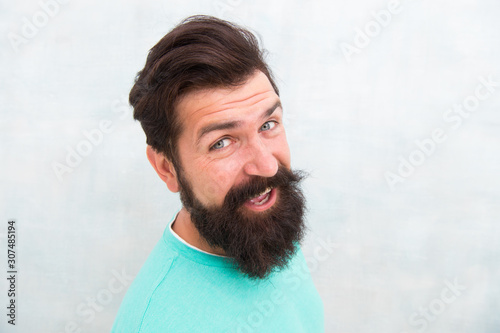 Perceptions of male beauty. Handsome guy close up. Masculinity concept. Man bearded hipster stylish beard grey background. Stylish beard and mustache care. Happy face. Beard fashion and barber © be free