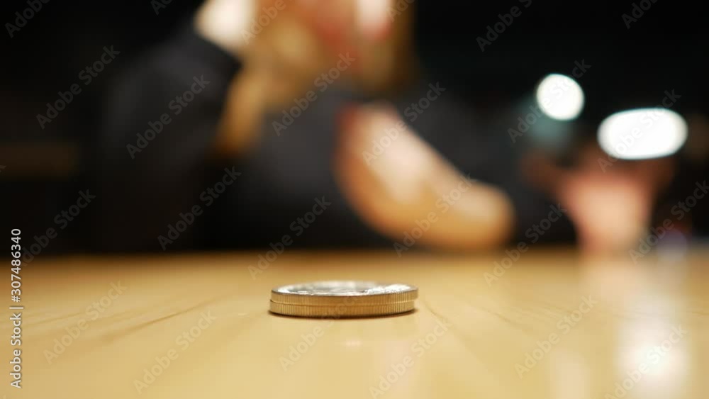 girl’s hand puts coins on the table one on one girl’s hand puts coins on the table one on one