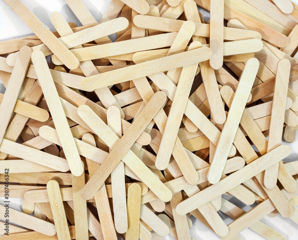 Scattered pile of wooden brown popsicle sticks. Scattered pile of wooden brown popsicle sticks.