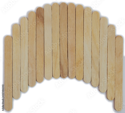 Wooden brown popsicle sticks arranged in an arc.