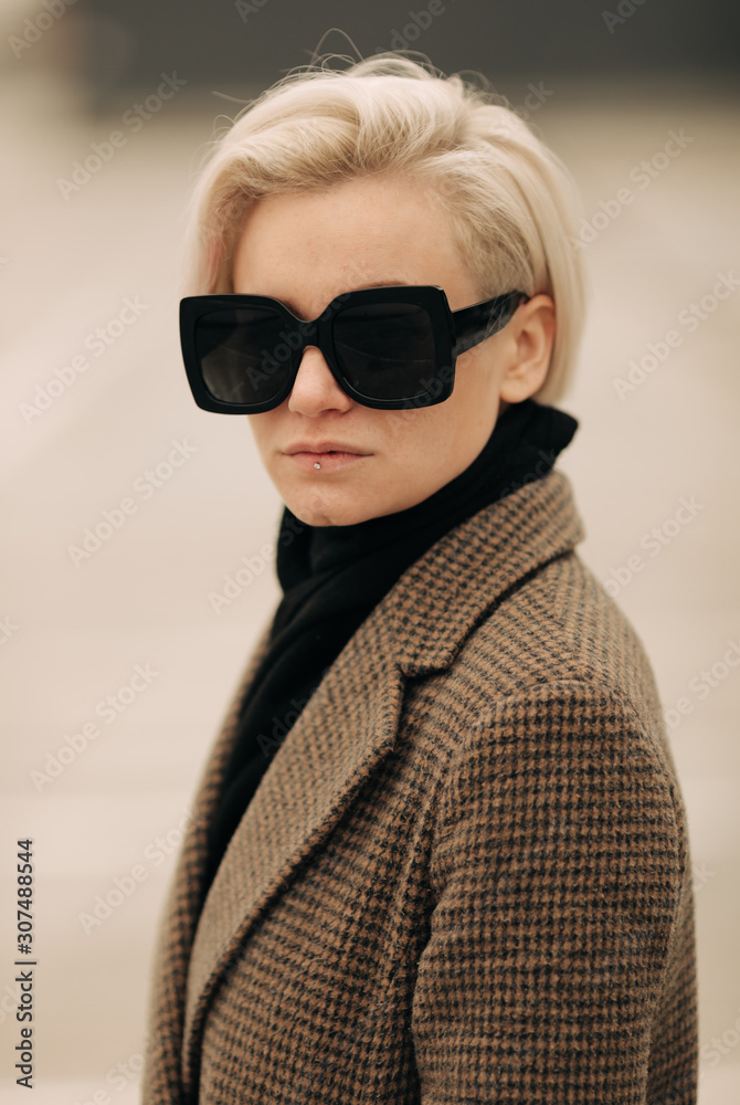Portrait Of Young Blond Androgyne Woman with big sunglasses Portrait Of Young Blond Androgyne Woman with big sunglasses