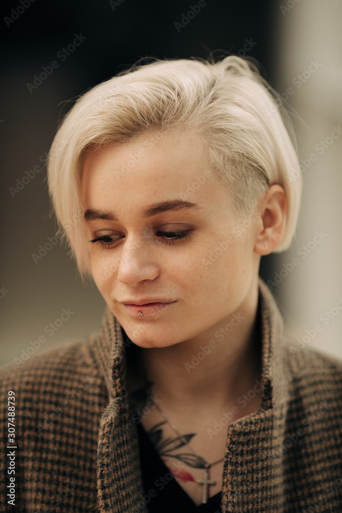 Portrait Of Young Blond Androgyne Woman On The Street