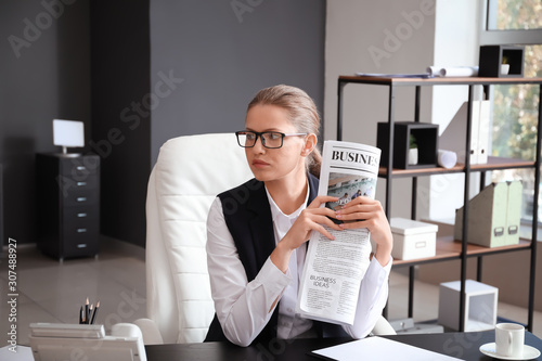 Young businesswoman reading...