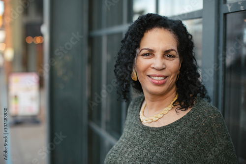 Joyful, happy mature woman outside.