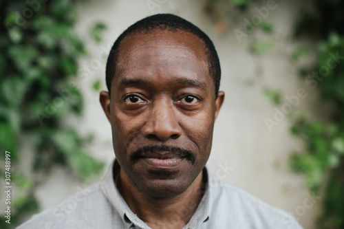 Serious but hopeful stare from a mature man.