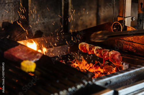 Shish kebab on professional grill station photo