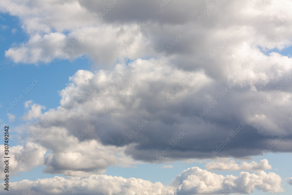 Obraz premium Cloudy blue sky with beautiful gray and white clouds.