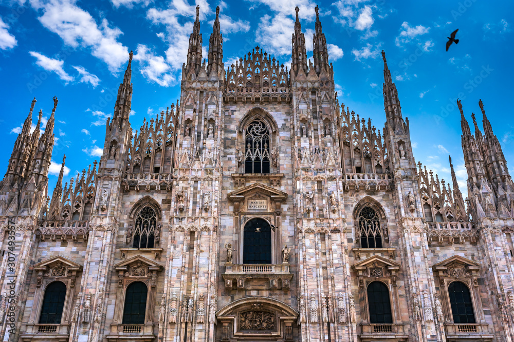 Fototapeta premium Milan Cathedral in Italy, known as Duomo di Milano is the largest and most complex Gothic building in Italy. Catholic church made of white marble.
