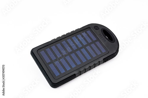 Portable charger using solar energy for mobile phones or tablets on white background