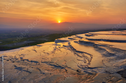 Beautiful sunrise and Natural travertine pools and terraces in Pamukkale.