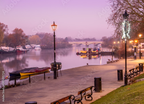 Small harbor on Richmond Thames riverbank and path walk illuminated at twilight in England - UK photo