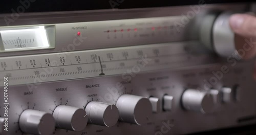 Vintage radio receiver and amplifier with fm scale. Tuning Analog Radio Frequency on Scale of the Vintage Receiver. Searching for stations on the old radio