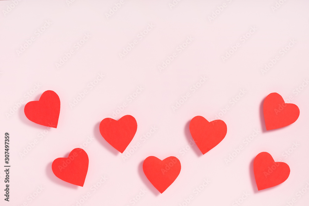 Valentine's day composition. Heart shape made of paper hearts on pink paper background. Valentine's day concept Valentine's day composition. Heart shape made of paper hearts on pink paper background. Valentine's day concept