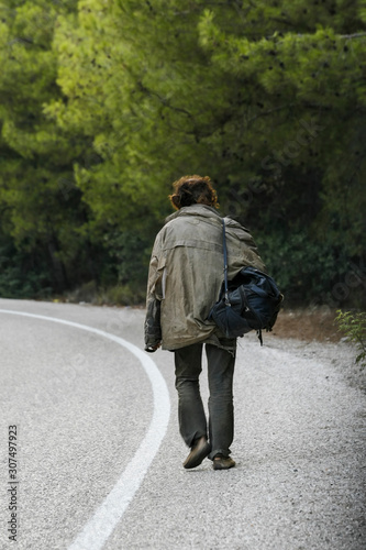 A homeless man walking alone on the road in Turkey
