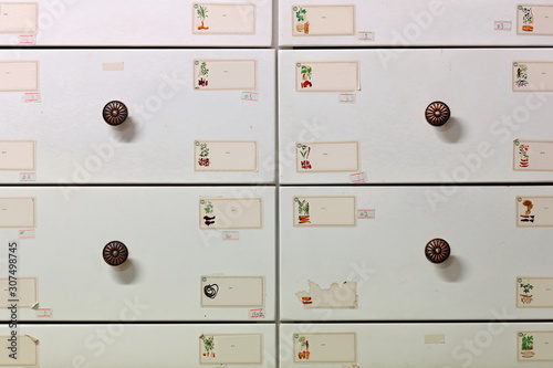 White drawer wall of a Chinese pharmacy. Ruoqiang Charkhlik town-Xinjiang-China-0418