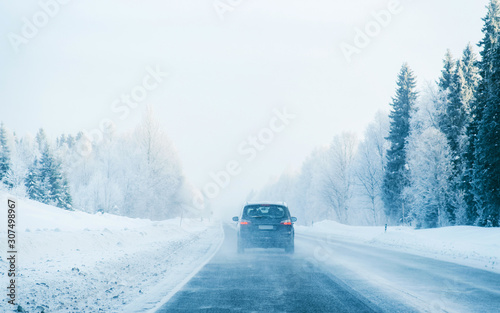 Car on Winter road with snow in Finland. Auto and Cold landscape of Lapland. Automobile on Europe forest. Finnish City highway ride. Roadway and route snowy street trip. Driving © Roman Babakin