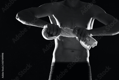 muscular man on black background © SHOTPRIME STUDIO