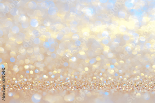 Colorful bokeh gold,yellow,blue abstract shining lights,sparkling glittering Valentines day,women day or event lights romantic backdrop.Blurred Christmas light or season greeting background.