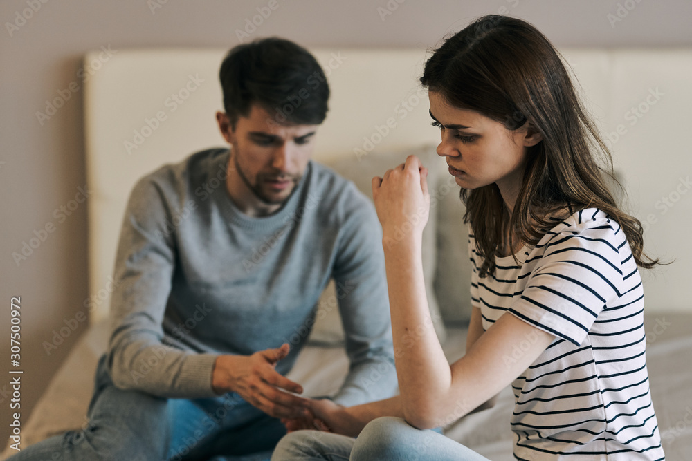 man and woman talking on cell phone