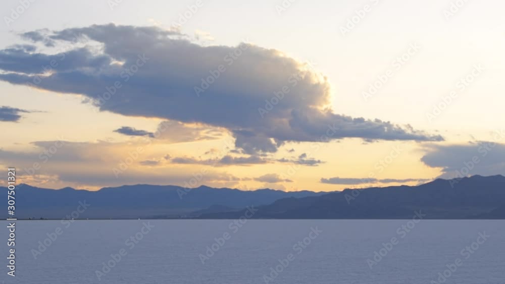Bonneville Salt Flats blue yellow landscape sunset near Salt Lake City, Utah and silhouette mountain view and clouds moving Bonneville Salt Flats blue yellow landscape sunset near Salt Lake City, Utah and silhouette mountain view and clouds moving