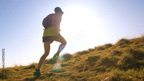 A man jogging up the hill in slow motion photo