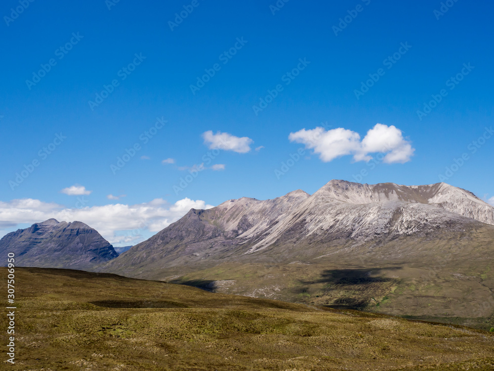 Scenic view of mountains against blue sky during sunny day, Scotland, UK Scenic view of mountains against blue sky during sunny day, Scotland, UK