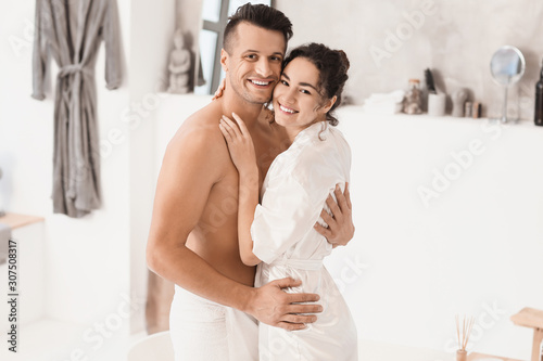 Happy young couple in bathr...