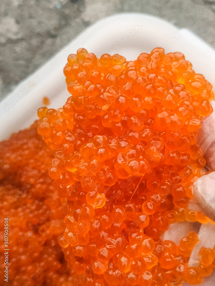 red caviar in plastic container. Salmon caviar, diet food. red caviar in plastic container. Salmon caviar, diet food.