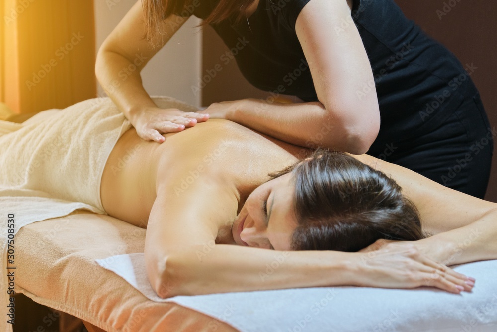 Fototapeta premium Professional back massage procedure, adult woman receiving treatment