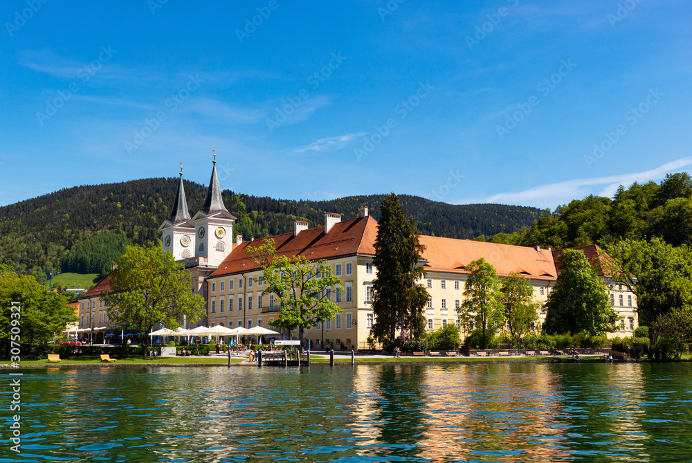 View of Tegernsee Abbey and St. Quirinus Church against blue sky during sunny day, Bavaria, Germany View of Tegernsee Abbey and St. Quirinus Church against blue sky during sunny day, Bavaria, Germany