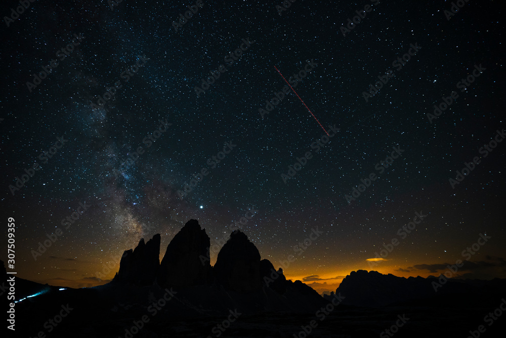 Scenic view of silhouette Tre Cime Di Lavaredo against star field at night, Italy Scenic view of silhouette Tre Cime Di Lavaredo against star field at night, Italy