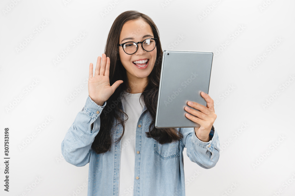 Happy woman making video call and greeting with hand isolated on white background