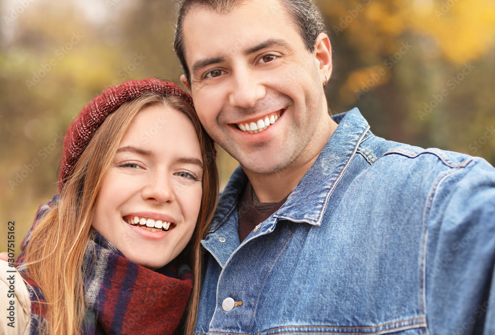 Happy couple taking selfie on autumn day Happy couple taking selfie on autumn day