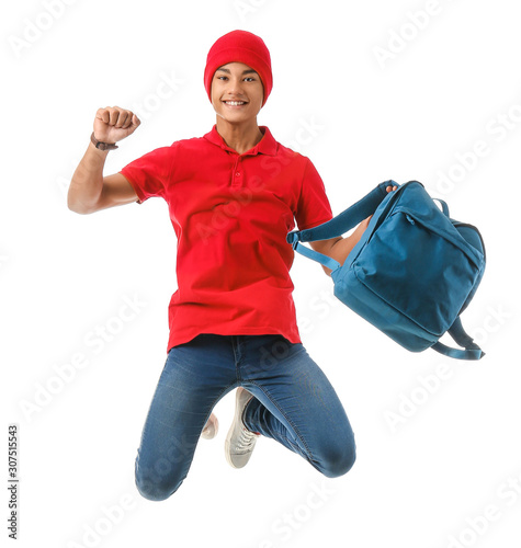 Jumping African-American teenager boy with backpack on white background