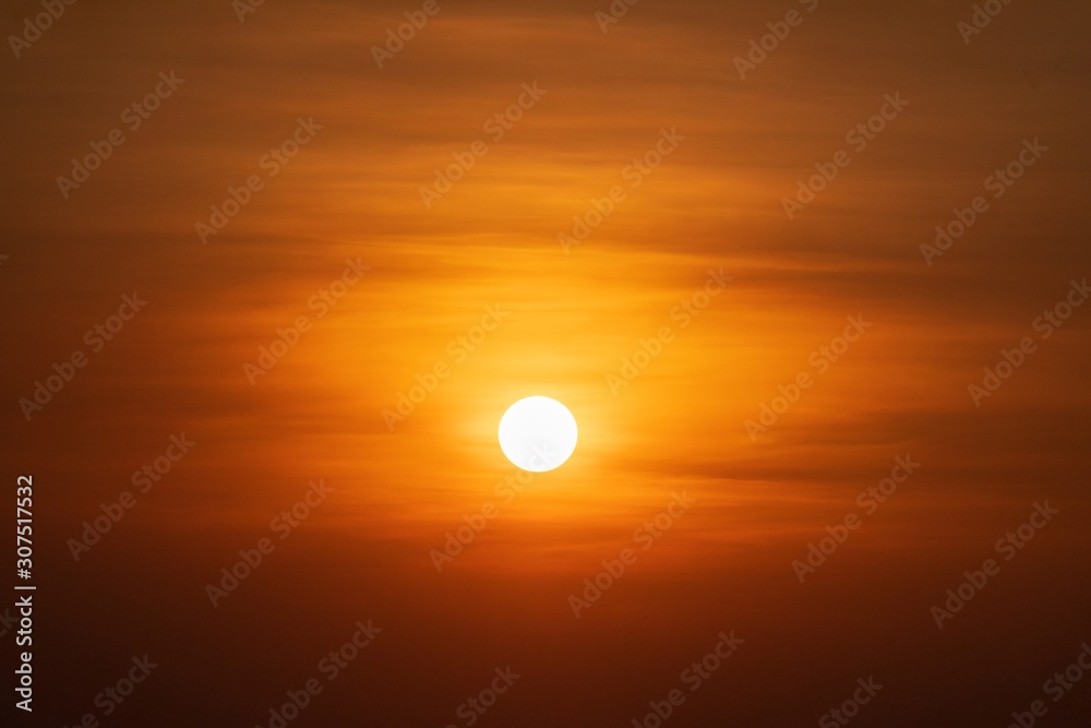 Beautiful sunset over sea. Tranquil scene of Closeup red sun and red sky sunset over the ocean Beautiful sunset over sea. Tranquil scene of Closeup red sun and red sky sunset over the ocean