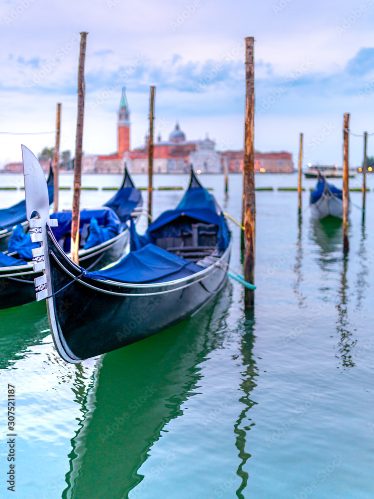 Gondolas on water in Venice, Italy. With Church of San Giorgio Maggiore in the background. 