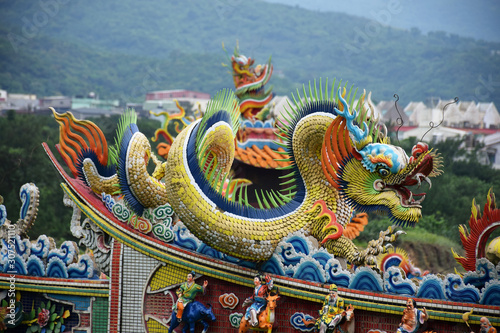 Yilan City, Taiwan - May 12 2017: Close up of a colorful dragon on an orange rooftop of a Taiwanese temple photo