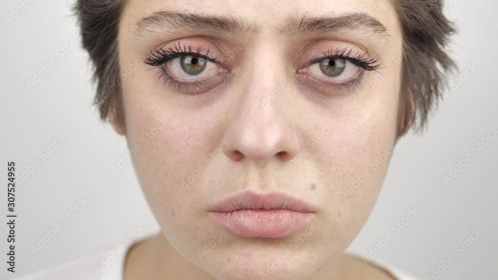 Close-up eyes of beautiful young woman brunette model looking at the camera. Girl with big eyes. 4k Close-up eyes of beautiful young woman brunette model looking at the camera. Girl with big eyes. 4k