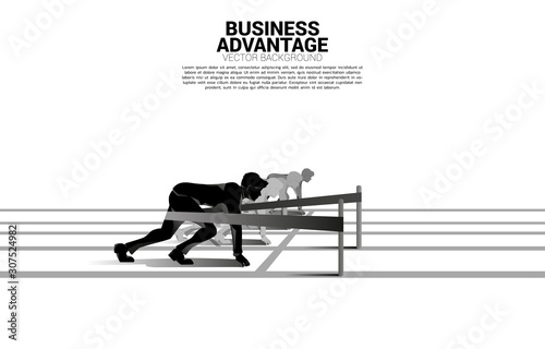 Business concept of competition and business advantage. Silhouette of businessman ready to run from start line with catapult sling shot on racing track.