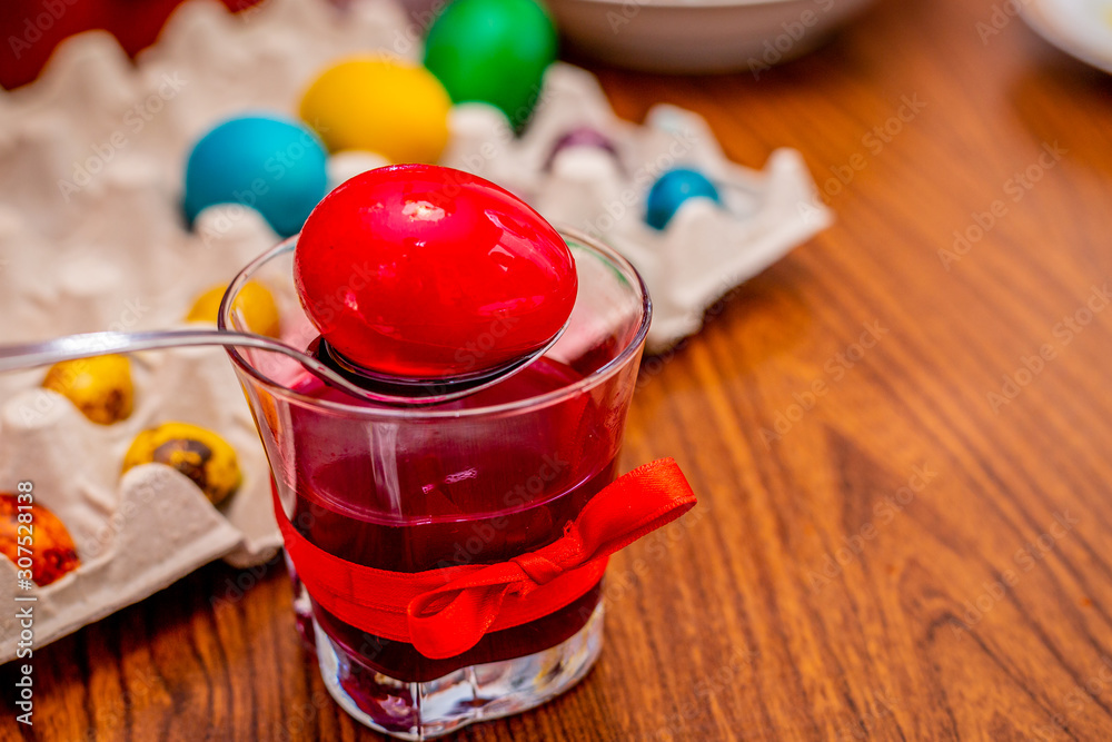 Painting a red easter egg in a with paint. Painting a red easter egg in a with paint.