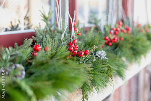 Photography Window box decorated for the holidays with fresh greens and red berries