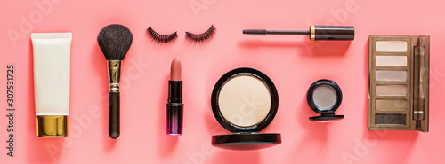 Make up items on pink color background. Horizontal web banner. Set of luxury decorative cosmetics flat lay, top view, mockup, template. Minimal style. Beauty blogger concept.