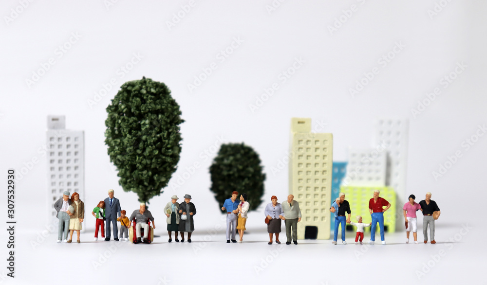 Any of various miniature families standing in front of miniature trees and miniature building. - obrazy, fototapety, plakaty 