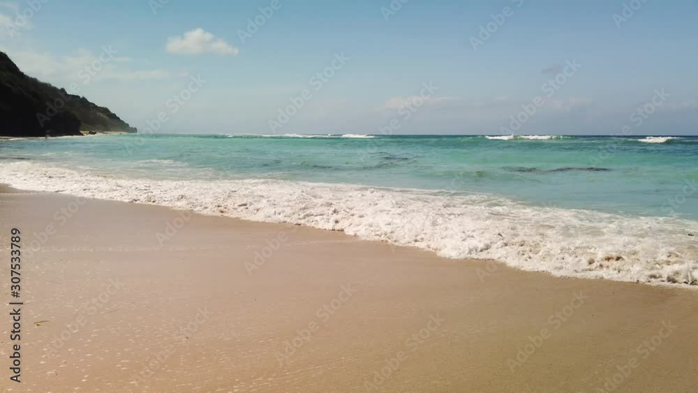 Pandawa Beach filmed with hand held 4k camera. Bali Indonesia stunning nature and ocean blue wavers crushing on the shore with beautiful yellow gold sand. Pandawa Beach filmed with hand held 4k camera. Bali Indonesia stunning nature and ocean blue wavers crushing on the shore with beautiful yellow gold sand.