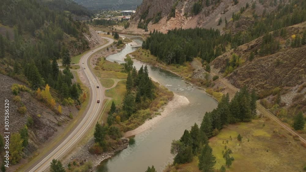 Flying high above road along rive through mountains (drone video) Flying high above road along rive through mountains (drone video)