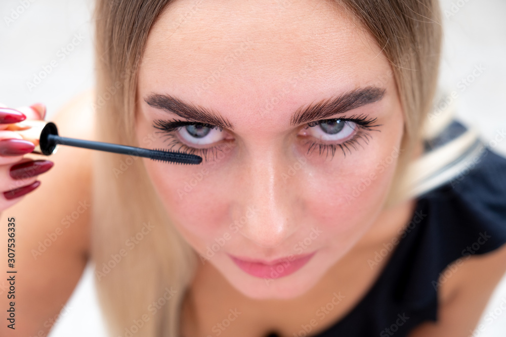 Female eyes with mascara brush. Female eyes with long eyelashes and a mascara brush. Female eyes with mascara brush. Female eyes with long eyelashes and a mascara brush.