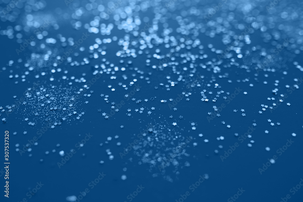 Classic blue color of year 2020. Festive elegant abstract background with bokeh lights and stars