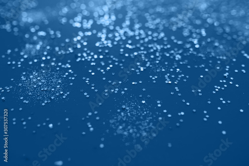 Classic blue color of year 2020. Festive elegant abstract background with bokeh lights and stars